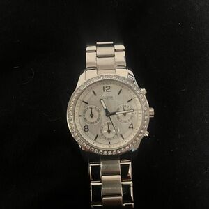 Guess silver tone watch with cubic zirconia stone around face. Classic design.